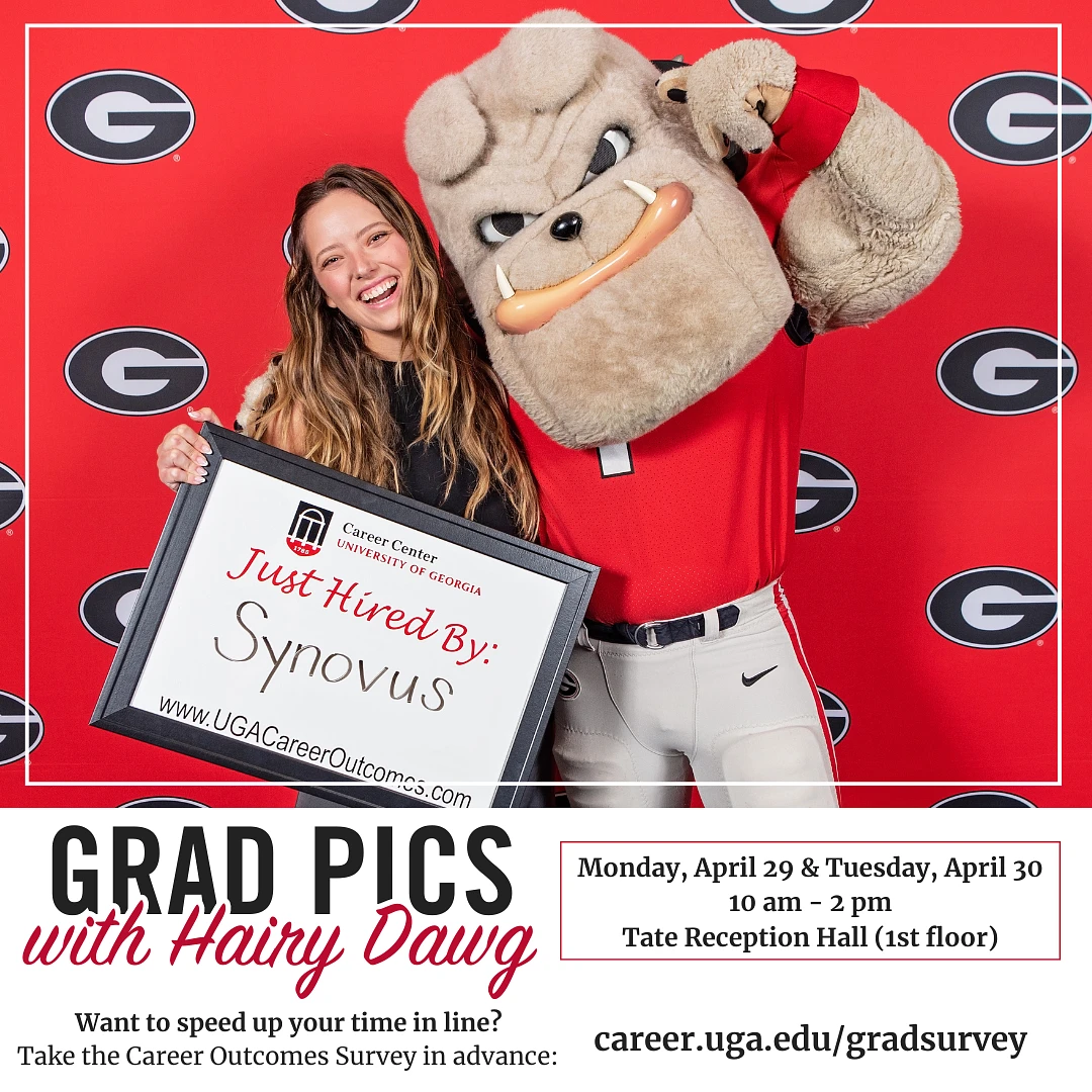 UGA student holding a sign that says "Just Accepted by Synovus" poses with Hairy Dawg in front of a red backdrop with the Power G